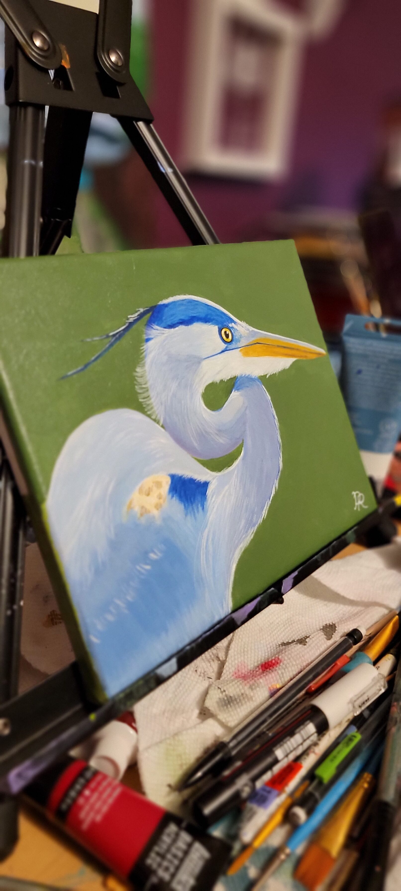 a painting of a blue heron on a green background