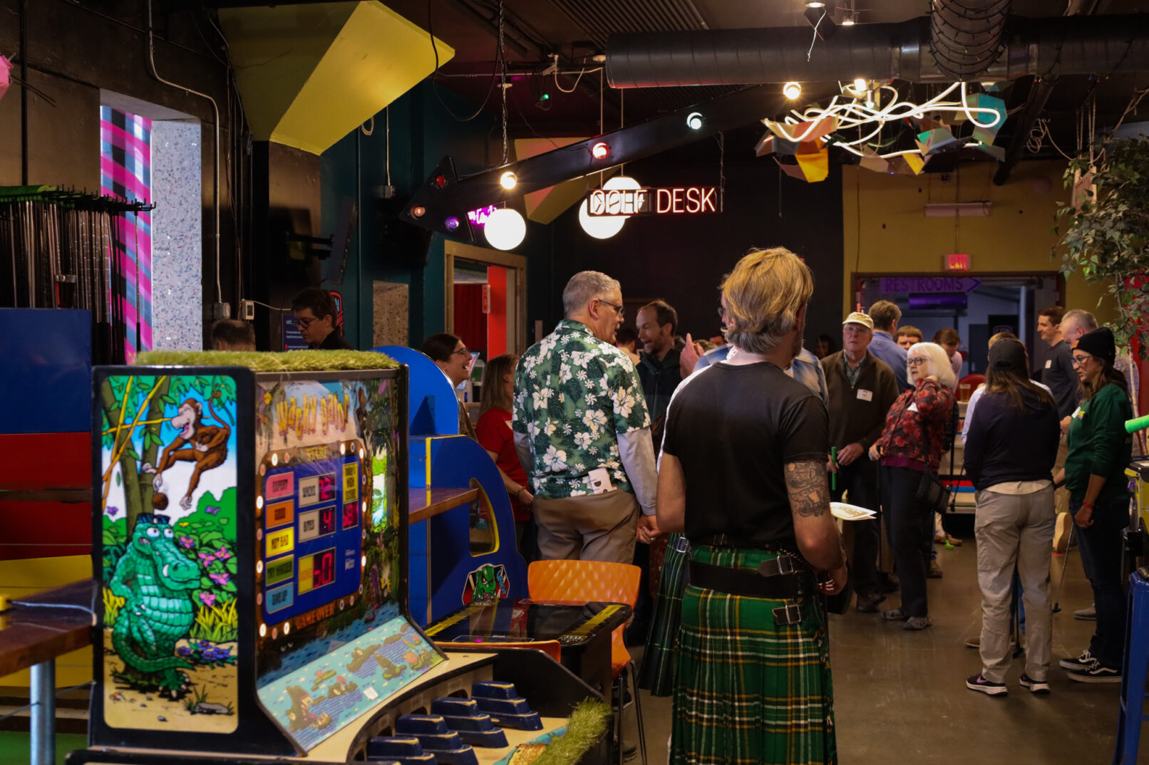 people standing in an arcade